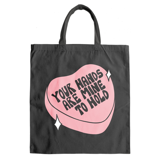 Black tote with pink heart that says Your Hands Are Mine to Hold